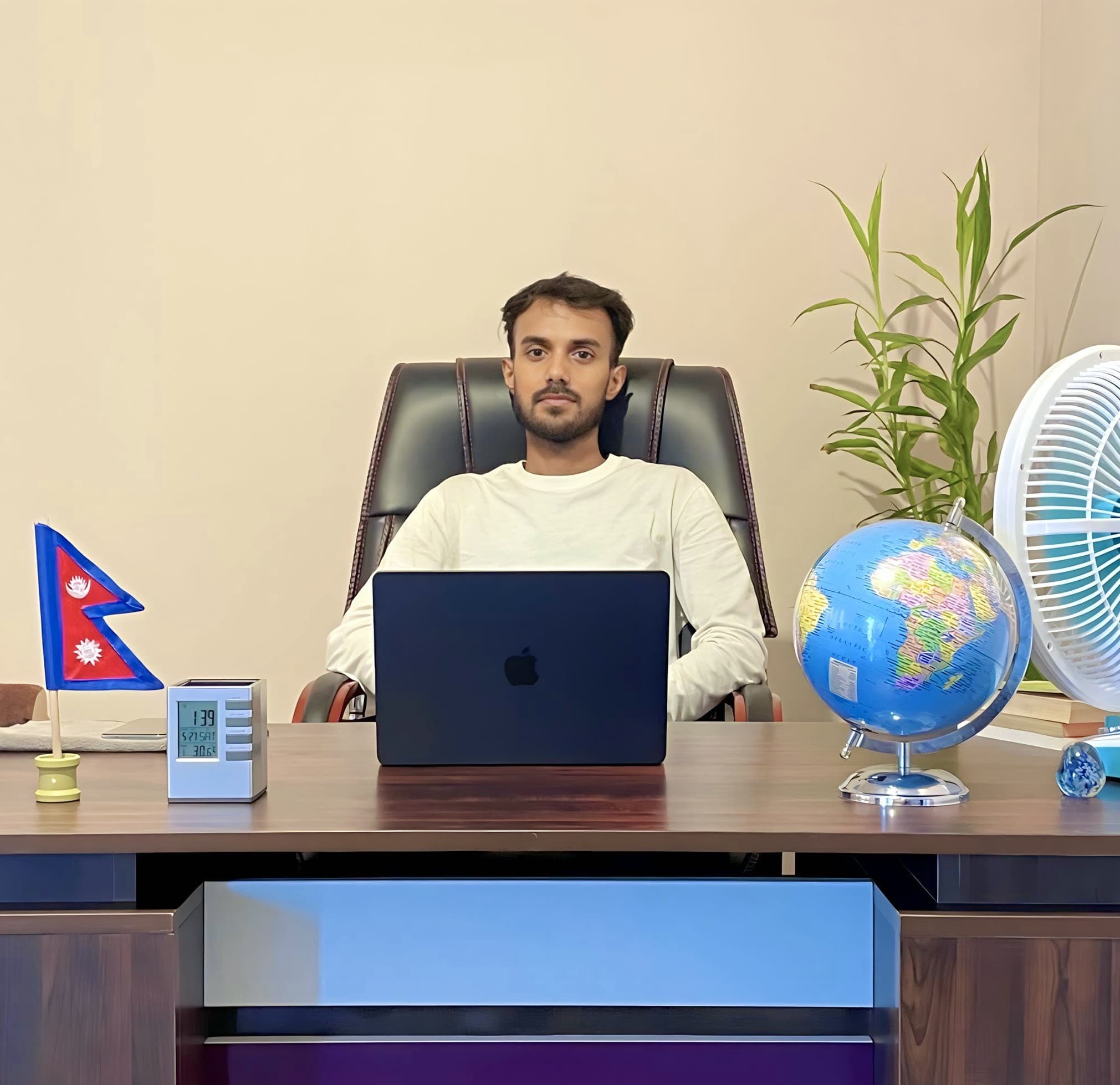 Bicky Giri seated at his office desk